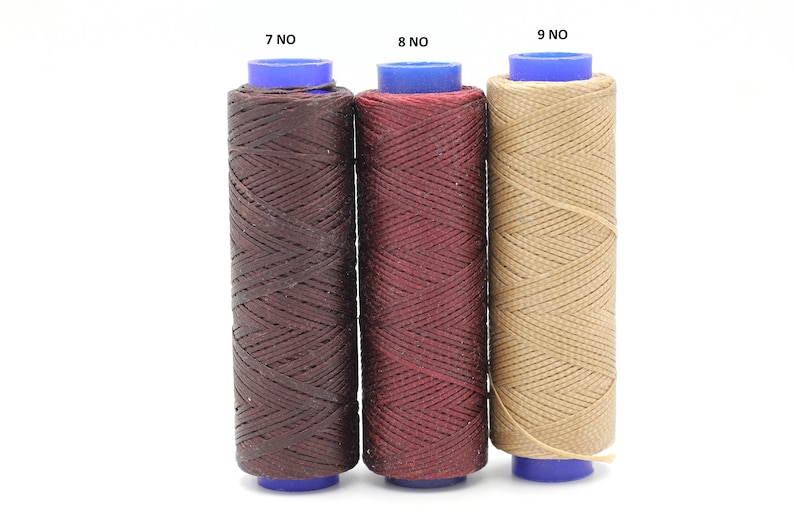 May include: Three spools of waxed thread in brown, burgundy, and beige colours. The spools are labelled 7 NO, 8 NO, and 9 NO.