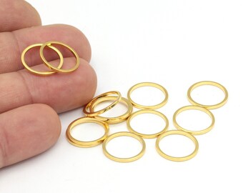May include: A set of ten gold-colored metal jump rings. The rings are of varying sizes and are arranged in a loose pile on a white surface.