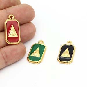 May include: Three gold-toned pendants with an all-seeing eye design. The pendants are rectangular with a gold border and come in red, green, and black enamel.