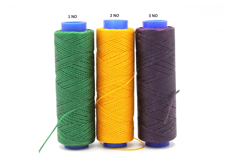 May include: Three spools of waxed thread, one green, one yellow, and one purple. Each spool has a blue plastic top and the text "1 NO", "2 NO", and "3 NO" printed on the top.