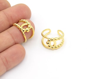 May include: Two gold-toned adjustable rings with a beaded design. The rings are open and can be adjusted to fit different finger sizes.