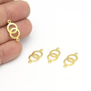 May include: Four gold-toned metal connector charms with a double circle design. Each charm has two jump rings for attaching to jewelry.