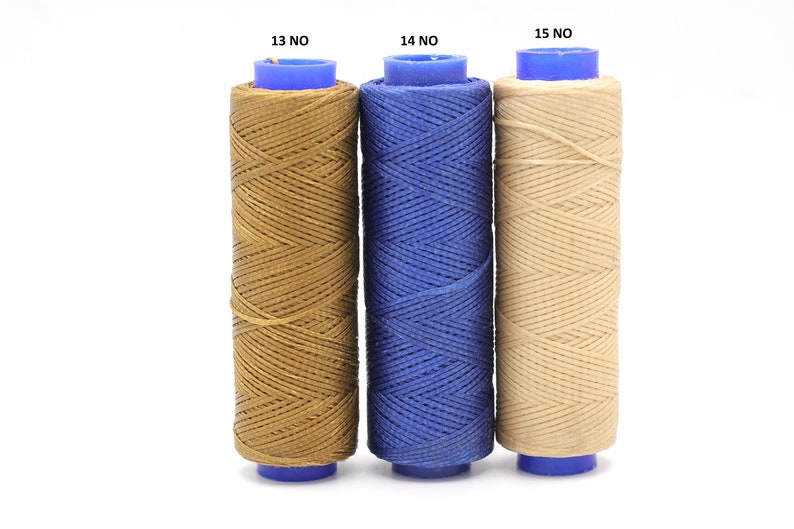 May include: Three spools of waxed thread, each in a different colour: brown, blue, and beige. The spools are labelled with the numbers 13, 14, and 15.