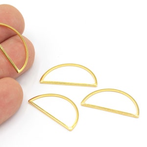 May include: Four gold-colored metal half-circle rings with a straight bar across the opening.