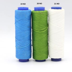 May include: Three spools of thread, one blue, one green, and one white. The spools are labelled 19 NO, 20 NO, and 21 NO.