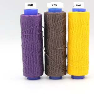May include: Three spools of waxed thread in purple, brown, and yellow. The spools are labelled 4 NO, 5 NO, and 6 NO.