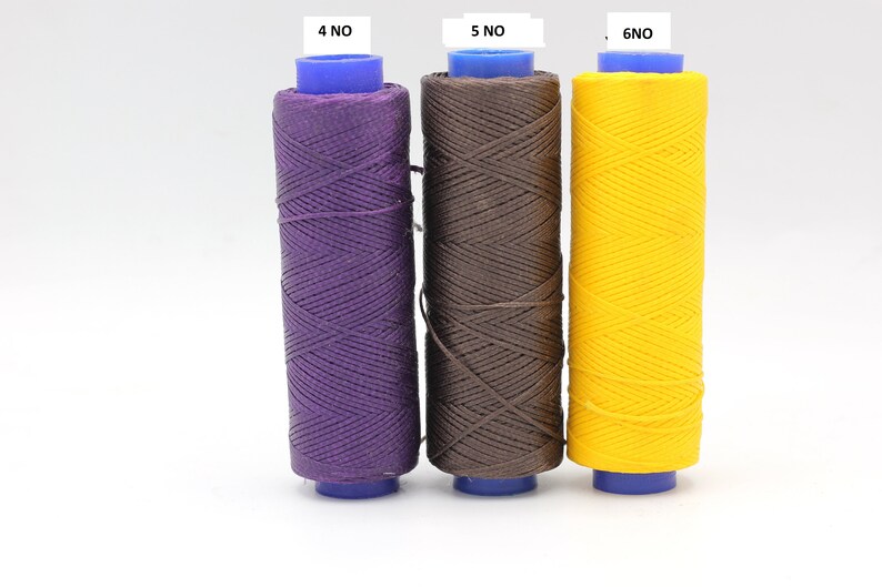 May include: Three spools of waxed thread in purple, brown, and yellow. The spools are labelled 4 NO, 5 NO, and 6 NO.
