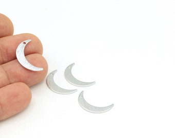 May include: Four silver crescent moon charms with a hole at the top for attaching to jewelry or other crafts.