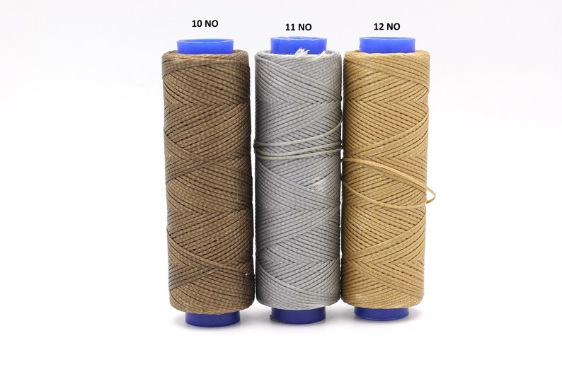May include: Three spools of thread in brown, grey, and beige colours. The spools are labelled 10 NO, 11 NO, and 12 NO.