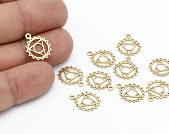 May include: Gold-colored metal charms with a geometric design. Each charm features a central triangle within a circle, surrounded by a sunburst pattern. The charms have a small loop at the top for attaching to jewelry or other crafts.