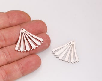 May include: Two silver-colored fan-shaped charms with a series of vertical lines and a small hole at the top for stringing. One charm is held in a hand, and the other is lying on a white surface. These charms are ideal for jewelry making.