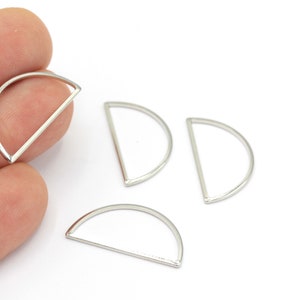 May include: Four silver half-circle metal rings, each with a flat bar across the open end.