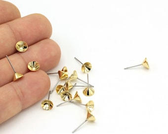 May include: A group of gold-colored metal earring findings with a small, round, cone-shaped top and a straight, silver-colored pin.