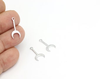 May include: Three silver metal crescent moon charms with a loop at the top for attaching to jewelry or other crafts.