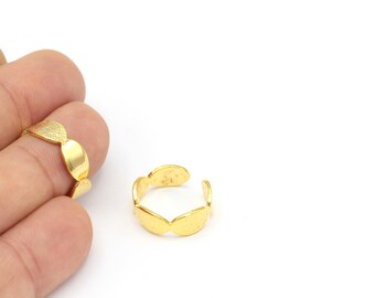 May include: Two gold rings made of small, round, textured pieces. The rings are open and adjustable.