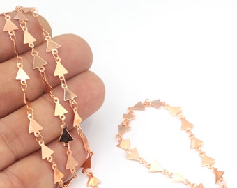 May include: A gold-toned chain with triangle-shaped links. The chain is made of metal and has a delicate, feminine look.