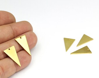 May include: Five gold triangle shaped metal charms with a hole at the top. The charms are approximately 2.5 cm in length.