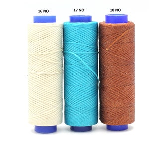 May include: Three spools of waxed thread, one white, one turquoise blue, and one brown. The spools are labelled 16 NO, 17 NO, and 18 NO.