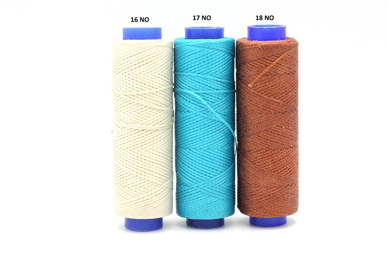 May include: Three spools of waxed thread, one white, one turquoise blue, and one brown. The spools are labelled 16 NO, 17 NO, and 18 NO.