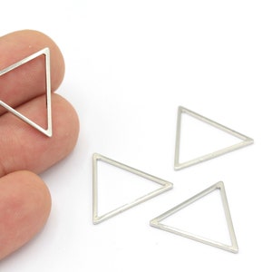 May include: Four silver triangle shaped metal charms. The charms are hollow and have a smooth, shiny finish.