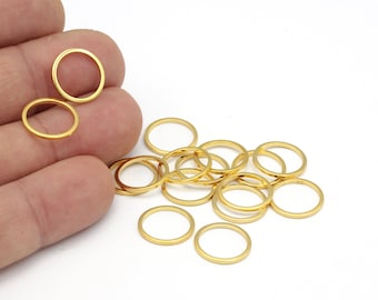 May include: A pile of gold-colored metal jump rings. The rings are small and round, and they are perfect for jewelry making.