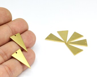 May include: A set of eight gold-toned triangle-shaped metal charms with a hole at the top. The charms are arranged in a fan shape on a white surface.