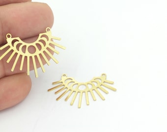 May include: Two gold metal sunburst pendant charms with a geometric design. Each charm has a half-circle shape with a series of radiating lines.