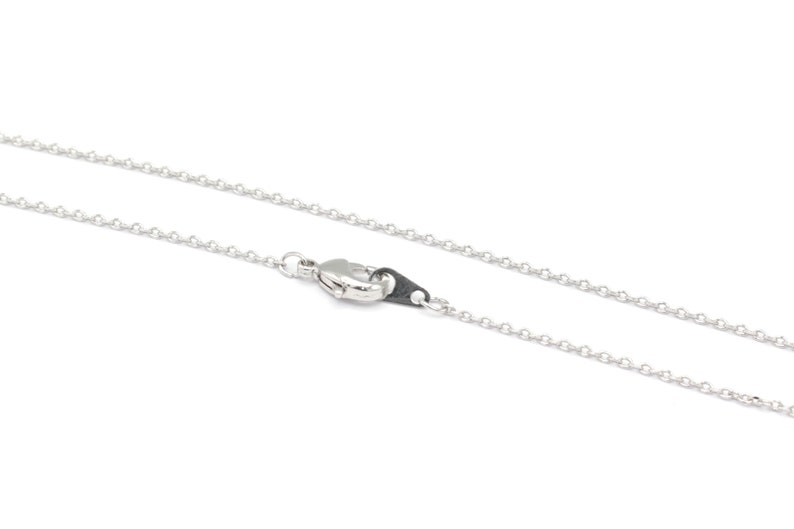 May include: A silver chain necklace with a lobster clasp.
