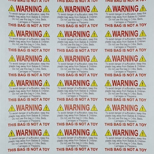 May include: A sheet of white warning labels with black text and yellow triangle warning symbols. Each label reads "WARNING" and provides safety instructions about plastic bags, including "THIS BAG IS NOT A TOY."