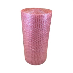 May include: A roll of pink bubble wrap, used for protecting items during transit. The wrap is tightly rolled, with individual air-filled bubbles for cushioning. The color is a soft, pastel pink, commonly used for packaging.