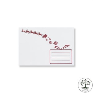 May include: White envelope with a burgundy illustration of Santa Claus in his sleigh, pulled by reindeer, delivering gifts. The envelope has a rectangular area with lines for the recipient's address and a bow design.