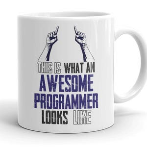 May include: White ceramic mug with a black and blue graphic. The text reads "THIS IS WHAT AN AWESOME PROGRAMMER LOOKS LIKE" with illustrations of hands pointing upwards.