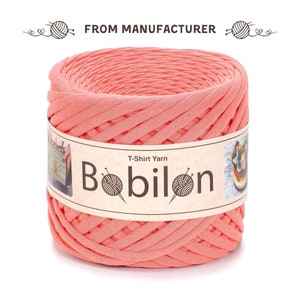 May include: A spool of coral pink T-shirt yarn, labelled "T-Shirt Yarn Bobilon".