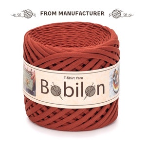 May include: A spool of rust-coloured T-shirt yarn, labelled "T-Shirt Yarn Bobilon".