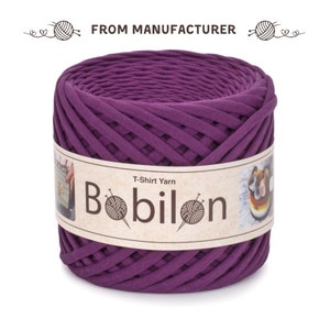May include: A spool of purple T-shirt yarn, labelled "T-Shirt Yarn Bobilon".