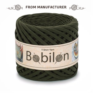 May include: A spool of dark green T-shirt yarn, labelled "T-Shirt Yarn Bobilon".
