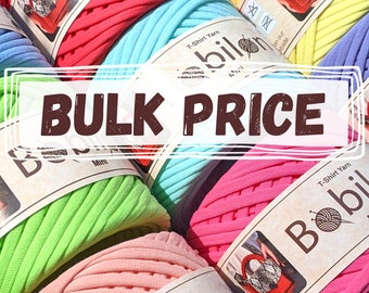 May include: A close-up of several colorful spools of t-shirt yarn. The spools are labeled "T-Shirt Yarn" and "Bobil". The text "BULK PRICE" is displayed in a brown rectangle.