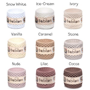 May include: Nine spools of Bobilon T-shirt yarn in various colors, including Snow White, Ice-Cream, Ivory, Vanilla, Caramel, Stone, Nude, Lilac, and Cocoa. Each spool is labeled with the Bobilon brand name.