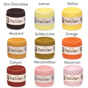 May include: Nine spools of Bobilon T-shirt yarn in various colors, including Hot Chocolate, Lemon, Yellow, Mustard, Golden Lime, Orange, Canyon, Marshmallow, and Macaroon. Each spool is labeled with the Bobilon brand name.