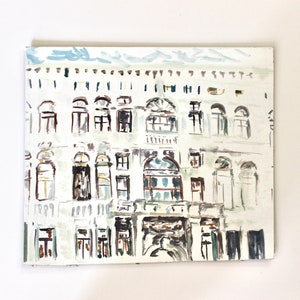 May include: An original painting of a building facade. The artwork depicts a white building with many windows and architectural details. The painting uses a muted colour palette with shades of white, grey, and brown, creating a vintage aesthetic.