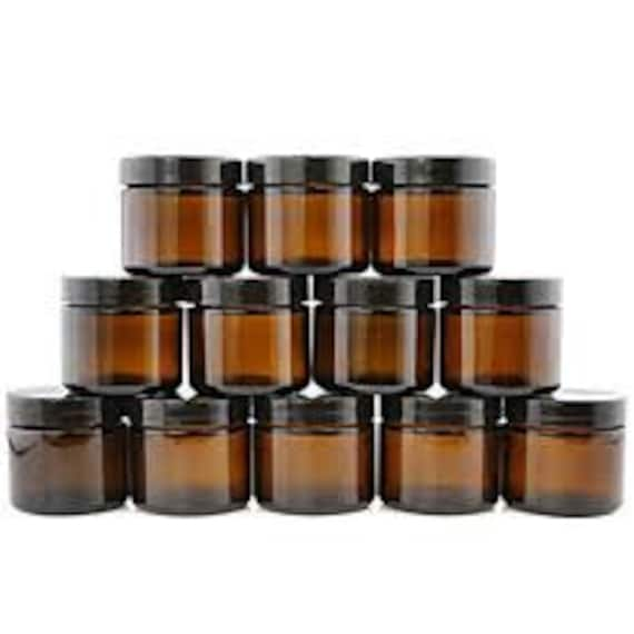 Glass spice jars with black plastic lids. 4 in tall. Diameter 2 in