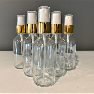 2 oz. (60 ML) Clear Boston Round Glass Bottle with Gold Fine Mist Sprayer | Great for serums | Essential Oils | Face Oils | Perfumes