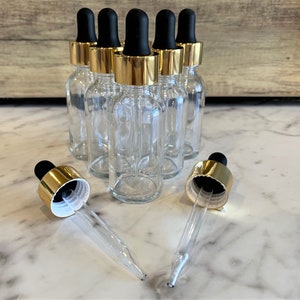 2 oz. (60 ML) Clear Boston Round Glass Bottle with Gold Glass Dropper | Black Top | Great for serums | Essential Oils | Face Oils