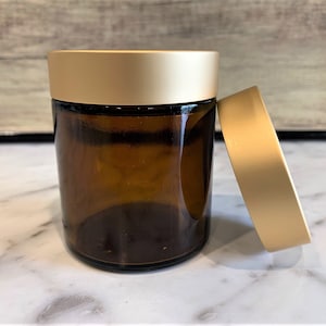 4oz Amber Glass Jar with Brushed Gold lid for Creams, skincare and essential oils.  The Gold Lid adds a touch of elegance to any products!