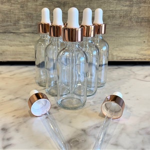 2 oz. (60 ML) Clear Boston Round Glass Bottle with Rose Gold Glass Dropper | White Top | Great for serums | Essential Oils | Face Oils