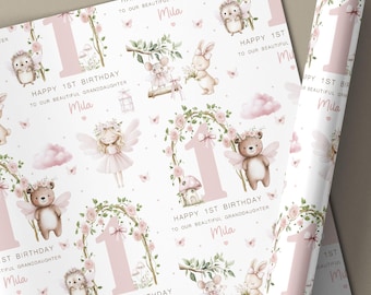 May include: Pink and white wrapping paper with a repeating pattern of woodland creatures, floral arches, and the number one. Text reads "Happy 1st Birthday to our beautiful granddaughter Mila." A matching card is available.