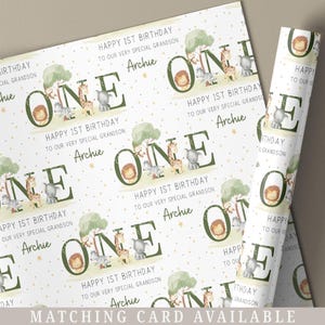 May include: White wrapping paper with a green and brown jungle animal theme. The paper features the word "ONE" repeated throughout the design. The text "Happy 1st Birthday to our very special grandson Archie" is repeated throughout the design.