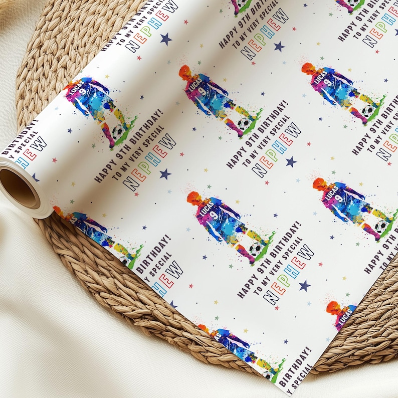 May include: White wrapping paper with a colorful soccer player graphic and the text "Happy 9th Birthday! To my very special Nephew". The paper is decorated with stars and the player's name "Lucas" is on the jersey.