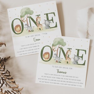 May include: Two green and white cards with the word "ONE" in large green letters. The letters are decorated with animal illustrations. The cards are personalized with the names "Evan" and "Thomas" and include a message about celebrating a first birthday.