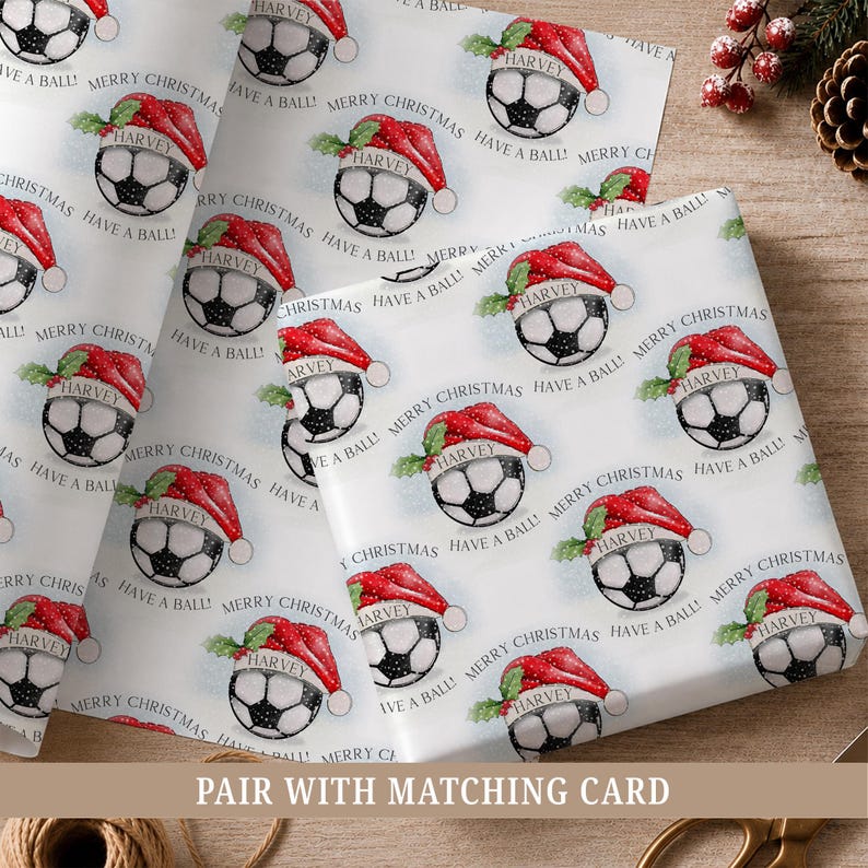 Personalised football Christmas wrapping paper featuring a festive football in a Santa hat, personalised with a name, relation and Have a Ball wording.